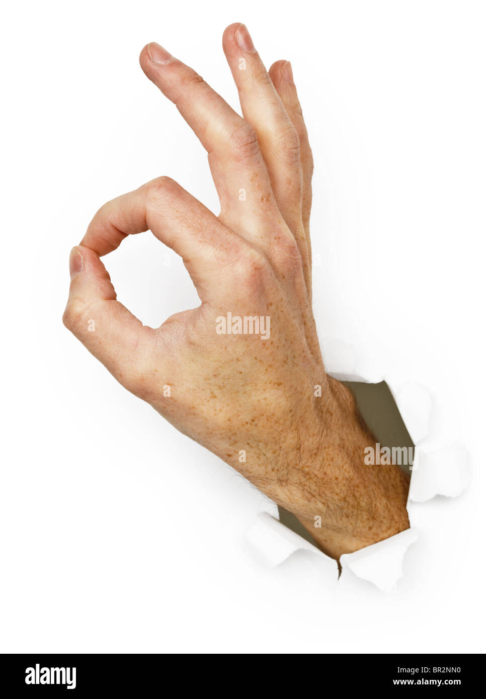 La mano con un gesto - Ok isolato su uno sfondo bianco Foto Stock