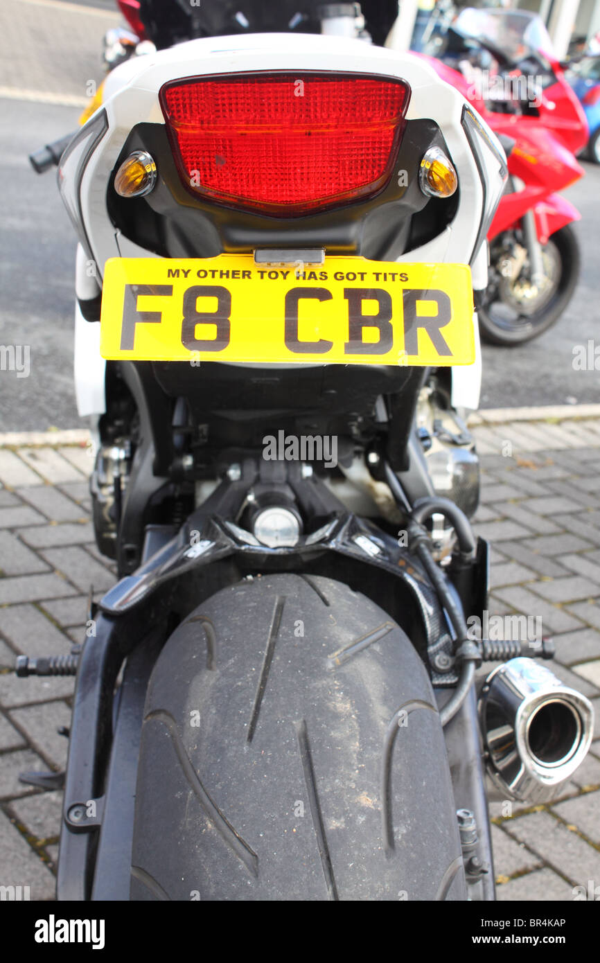 Registrazione personalizzata su un formato illegalmente numero di targa, con sessista slogan su una sportsbike. Foto Stock
