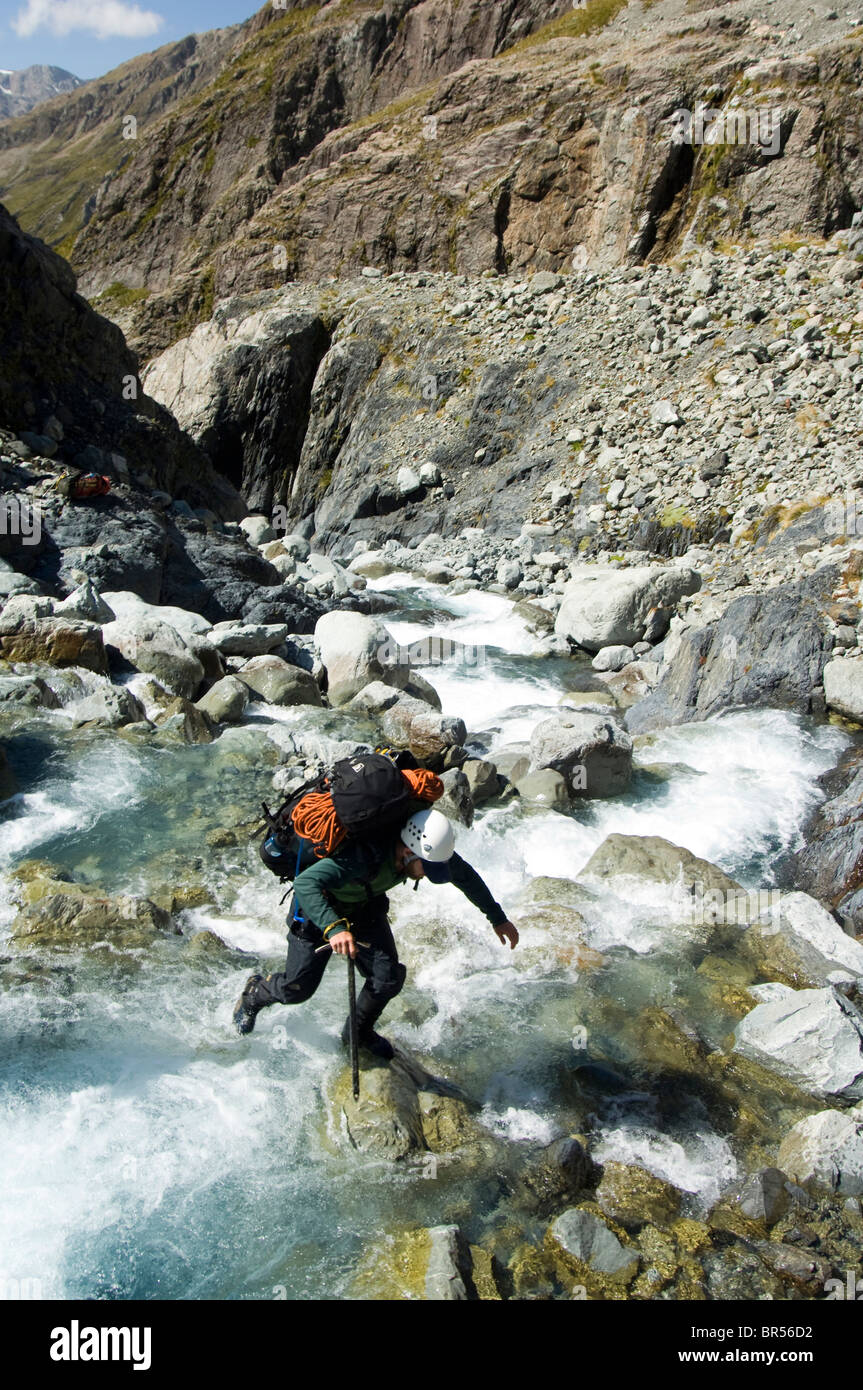Nuova Zelanda, Isola del Sud, Arthurs Pass National Park. Michael Caino attraversando il Fiume Bianco. Foto Stock