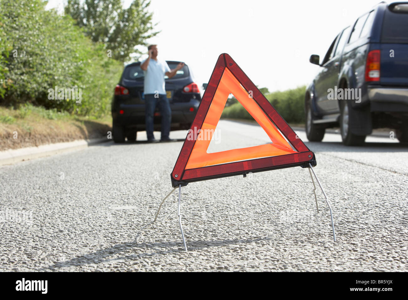 Autista ripartiti sulla strada di campagna con luci di avvertimento segno in primo piano Foto Stock