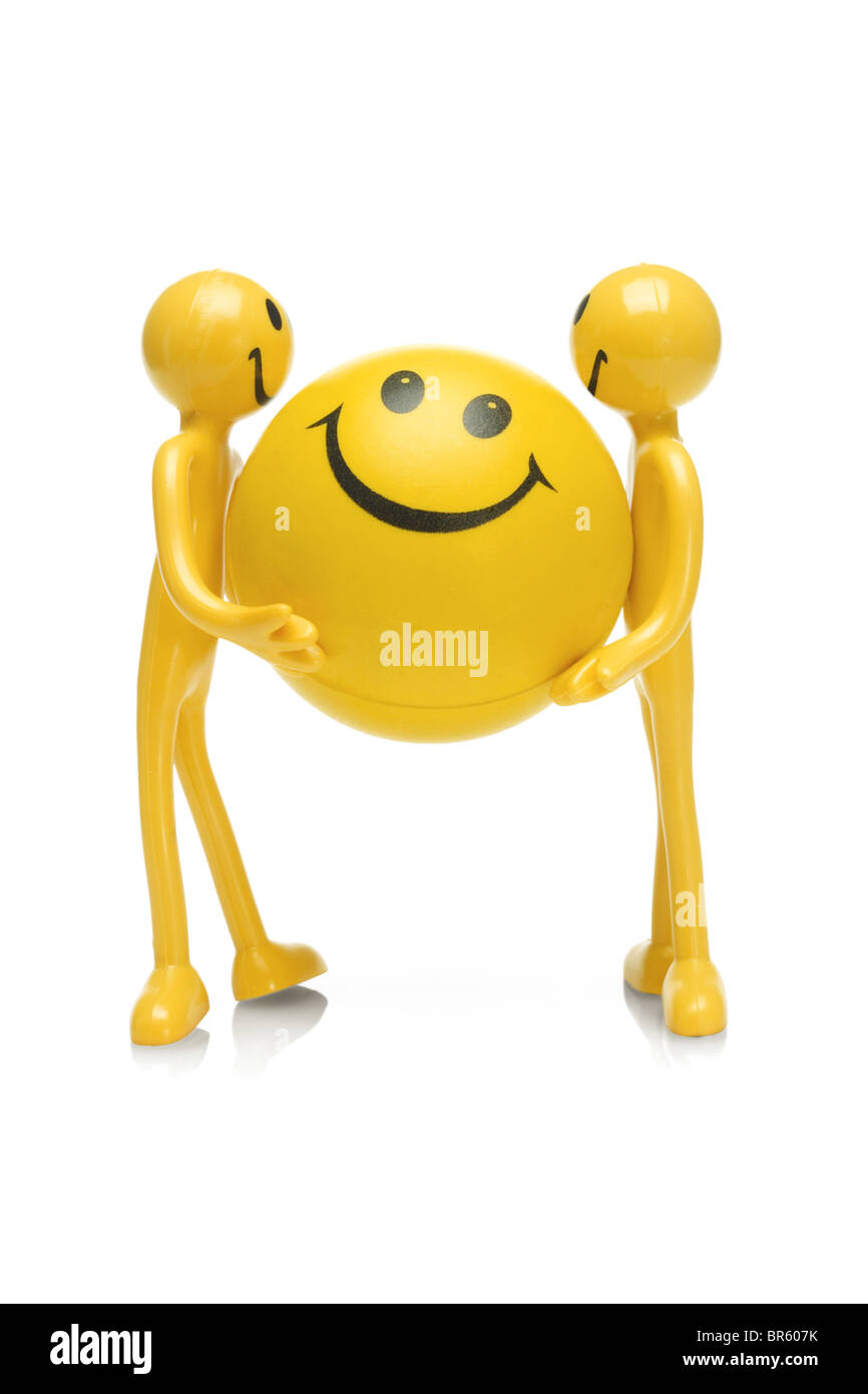 Smiley figurine azienda grande palla smiley su sfondo bianco Foto Stock