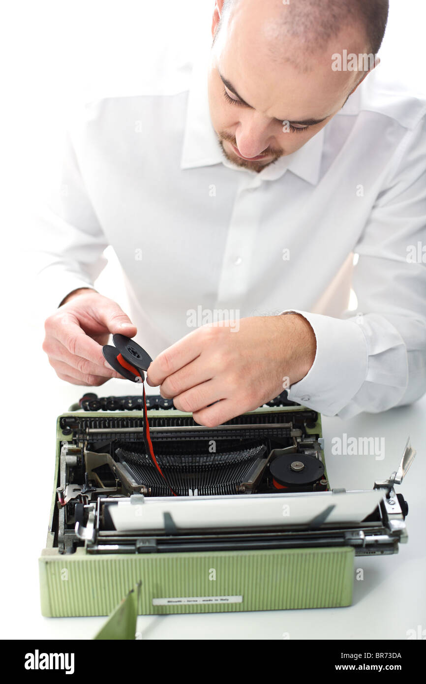 Uomo di provare a risolvere i nastri inchiostratori per macchine da scrivere vintage il fuoco selettivo immagine Foto Stock