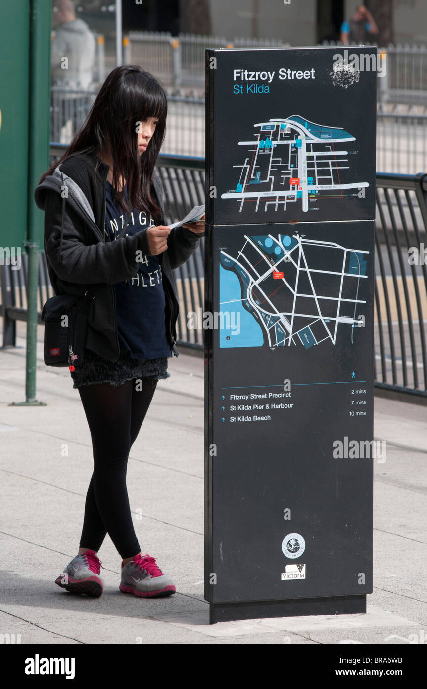 Un giovane turista giapponese guardando una mappa di Fitzroy Street, St Kilda a Melbourne Foto Stock