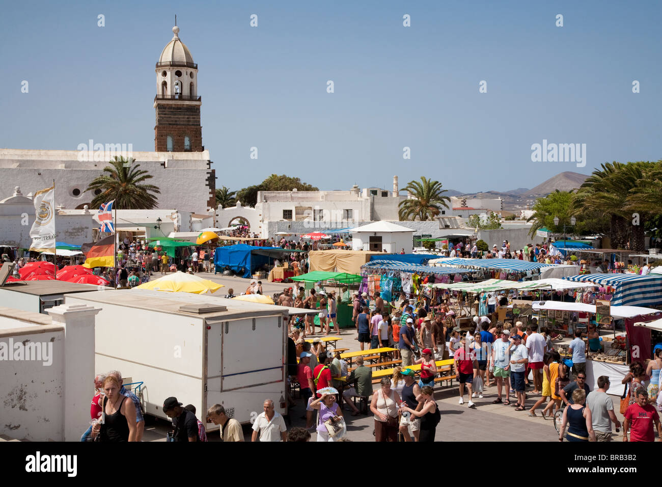 La folla al mercato di domenica con la torre campanaria di Iglesia de San Miguel in background, Teguise, Lanzarote Foto Stock