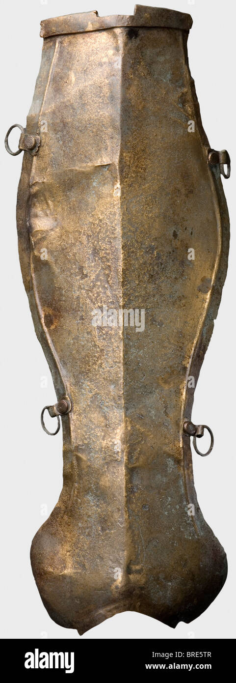 Un greave romano, 2nd/3rd secolo A.D. Essenzialmente non decorato, in ottone greave con una cresta centrale. Sfalsare i bordi lungo i bordi con quattro alette rivettate e anelli grandi per il fissaggio delle cinghie. Una rientranza sulla parte superiore per fissare la cerniera della protezione ginocchia e una protezione estesa della caviglia sull'estremità inferiore lunghezza 36 cm. Peso 135 g. Il metallo è molto ben conservato, con alcuni supporti e restauri sul bordo e sull'estremità inferiore Axel Guttmann Collection (R 69/AG 307). Provenienza: Acquisita nel 1989 a Dinkelsbühl, presumibilmente da Paks sul Danubio/Ungheria. Pubblicato in: H, Foto Stock