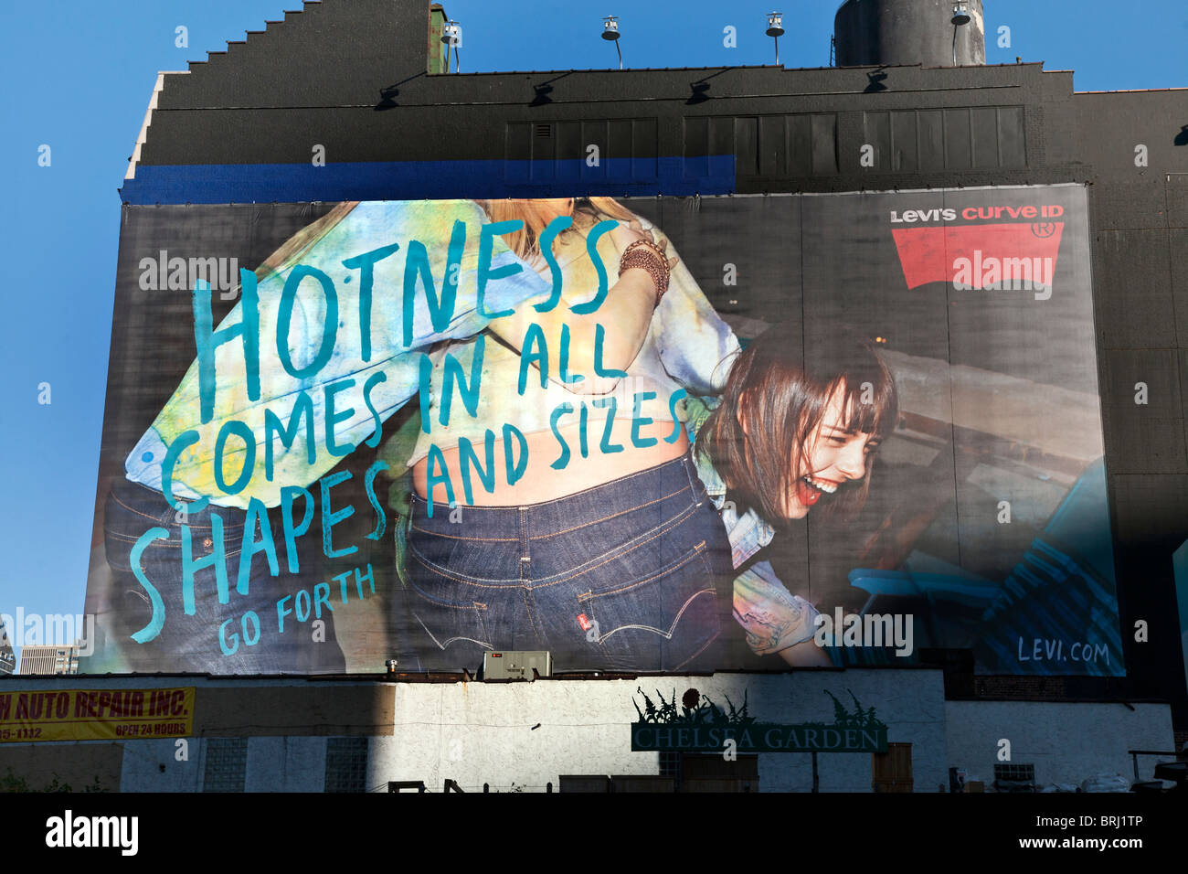 Alla moda di Levi's jeans pannello pubblicitario con graffiti scrawled in stile testo sulla parete del west side di Manhattan Building di New York City Foto Stock