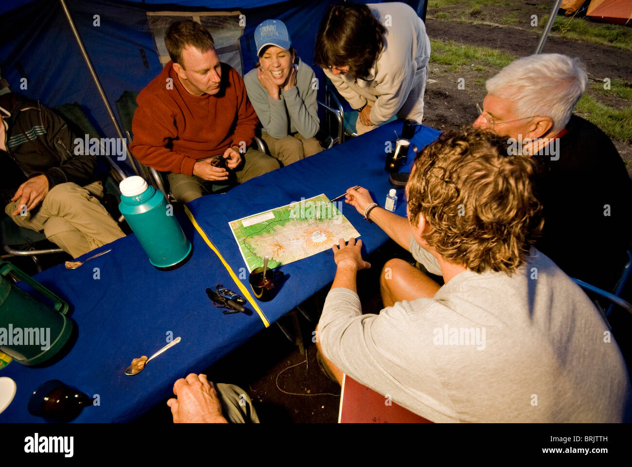 Un gruppo di escursionisti discutere la prossima giornata di piani sulla loro strada per la vetta del Monte Di Kilimanjaro. Foto Stock