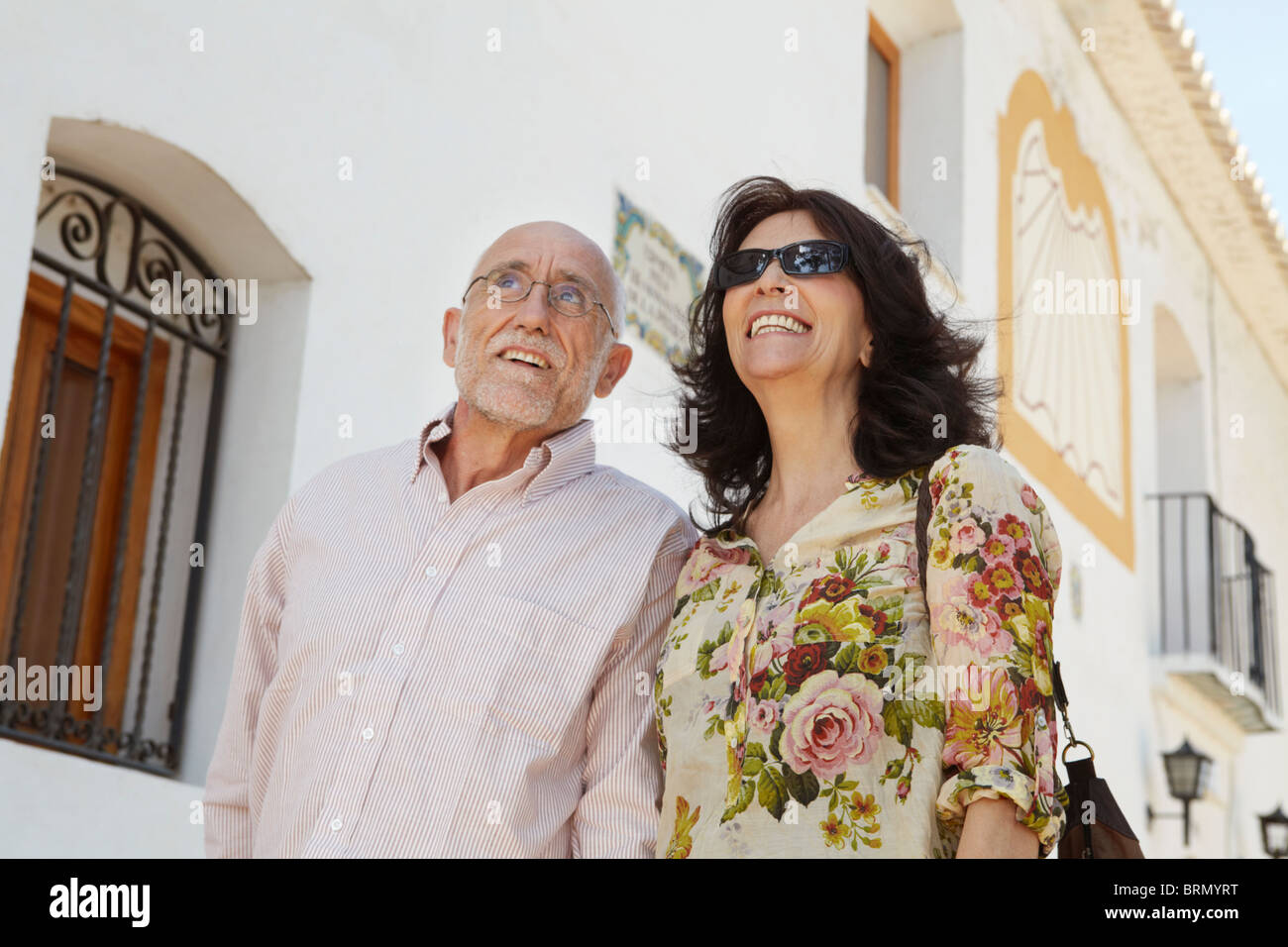 Coppia di anziani passeggiando passato vecchia chiesa Foto Stock