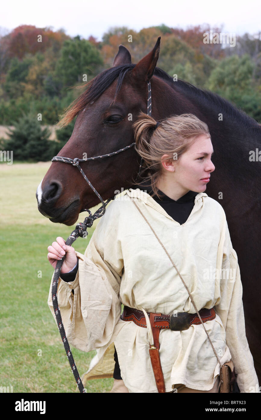 Un cavallo arabo detenute da una giovane ragazza in un western frontier outfit Foto Stock