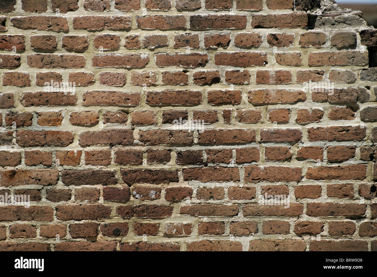 Il marrone scuro muro di mattoni con apertura in alto a destra Foto Stock