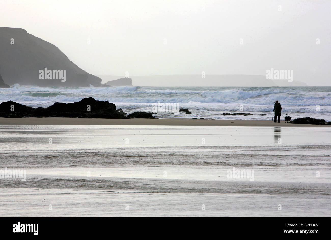 Uomo che cammina cane sulla spiaggia Porthtowan, Cornwall, Inghilterra Foto Stock