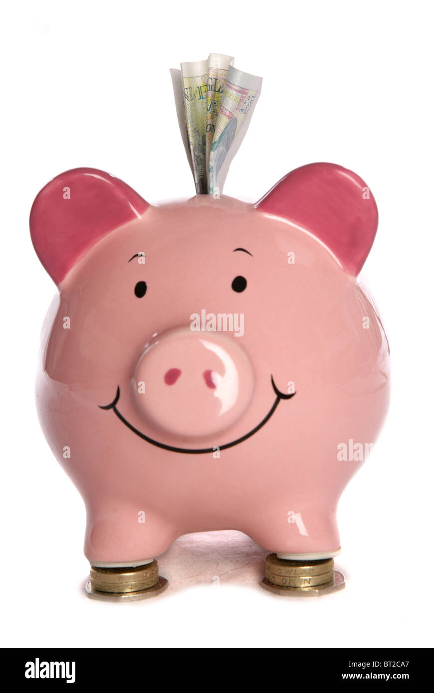 Piggybank con cinque Pound sterling studio ritaglio Foto Stock