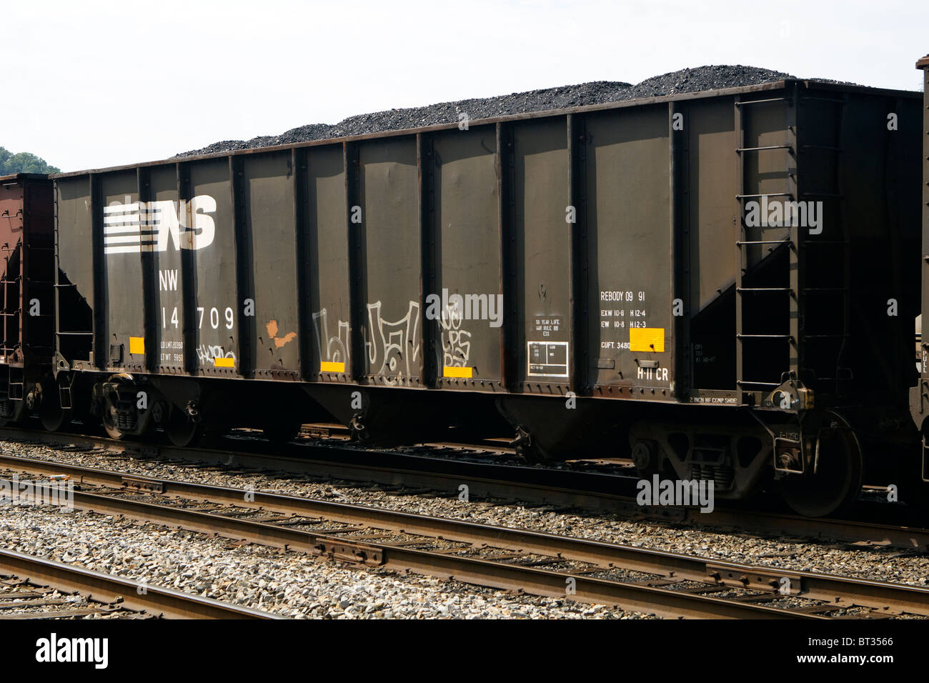 Uno Norfolk Southern auto di carbone nel mezzo di un treno di vetture di carbone in un railyard in West Virginia, Stati Uniti d'America su un nuvoloso giorno. Foto Stock