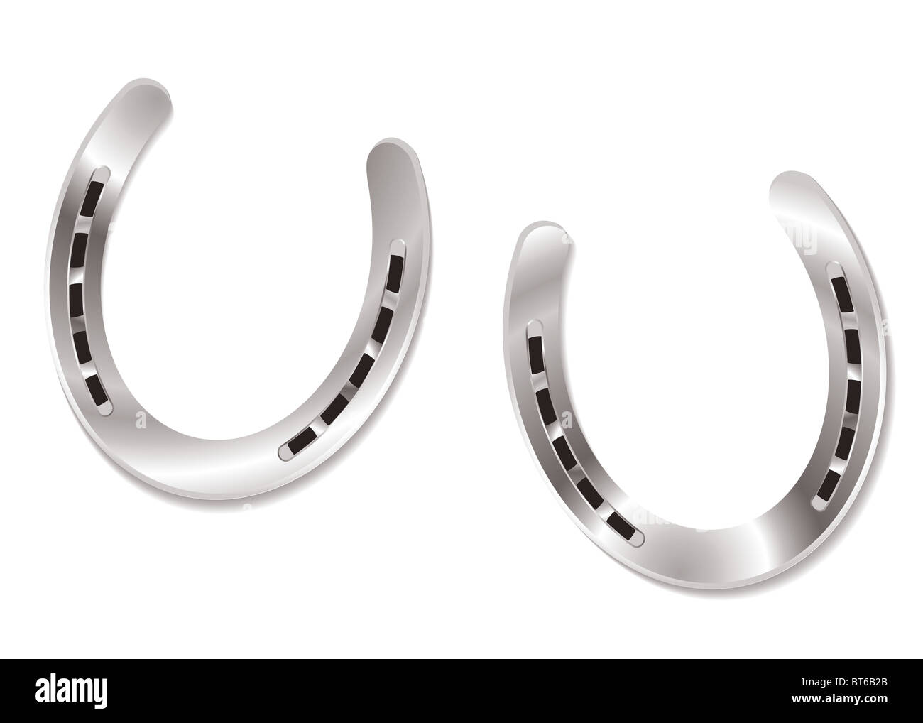 Due ferri di cavallo in argento con la riflessione della luce fascino fortunato concetto Foto Stock