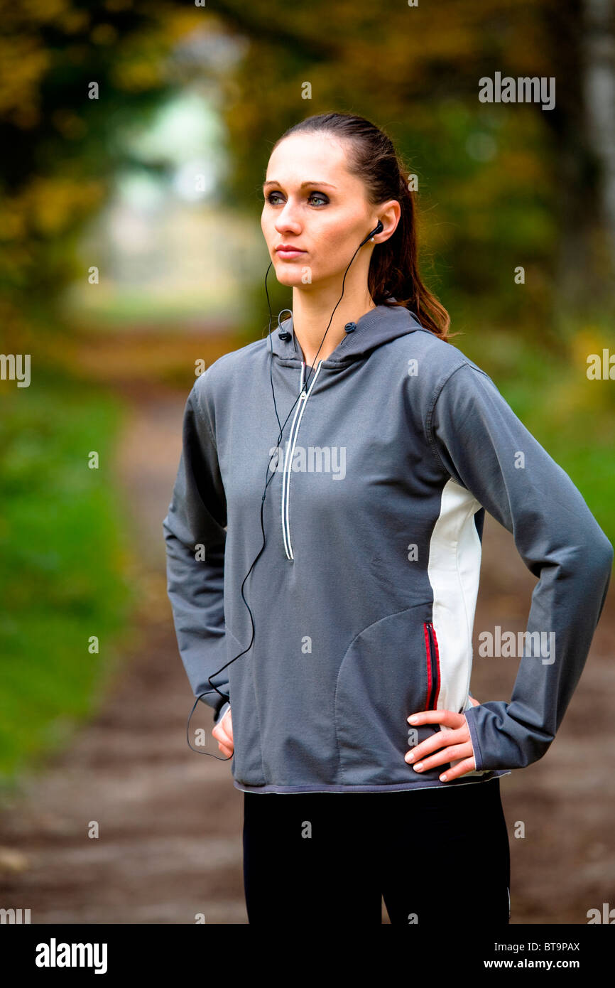 Giovane donna in fase di riscaldamento prima di fare jogging Foto Stock