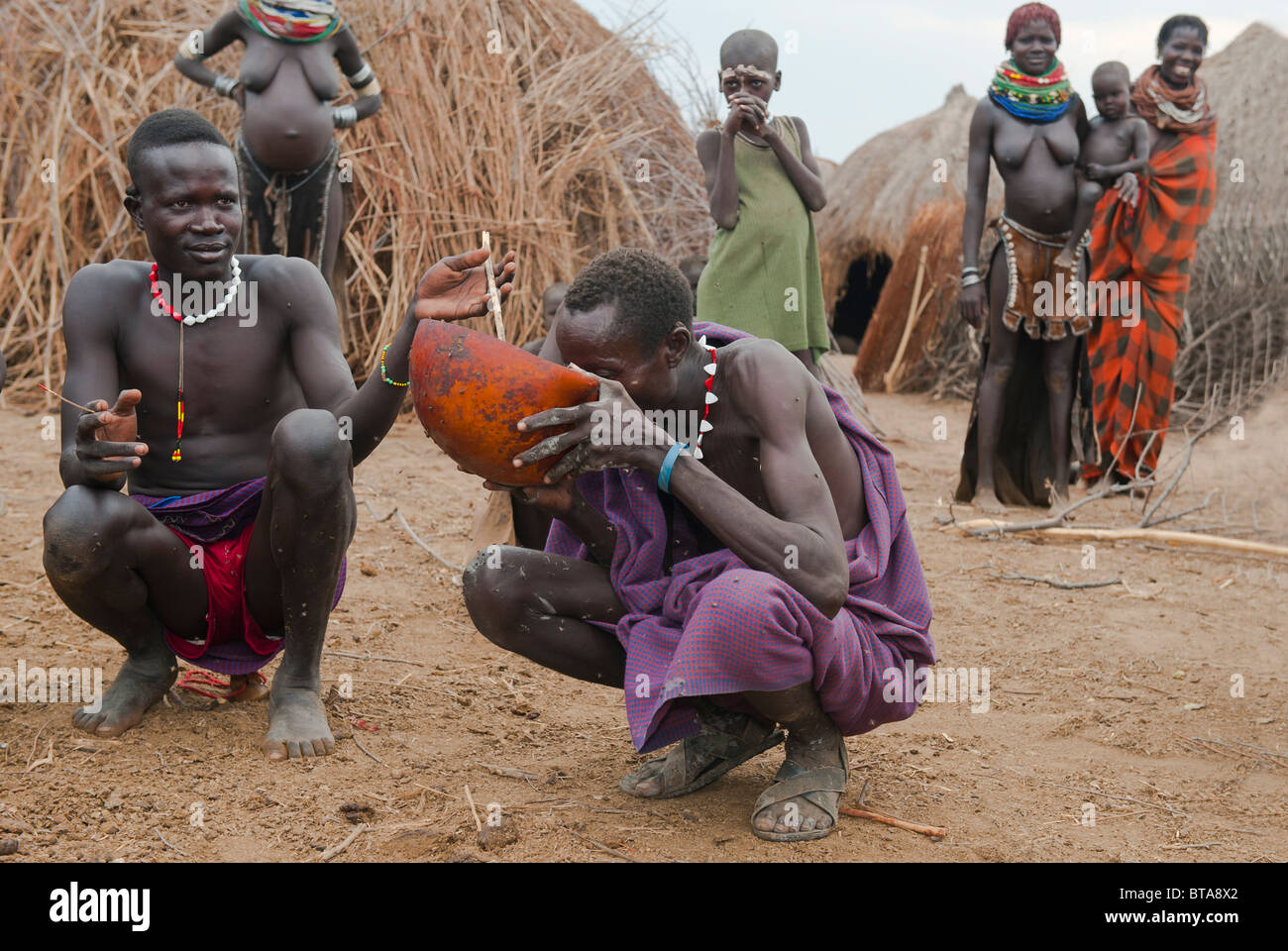 Nyangatom (Bumi) uomo bere un mix di sangue e di latte, Omo river valley, Etiopia Foto Stock
