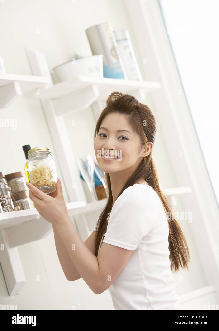Donna che mantiene un vasetto di storage Foto Stock
