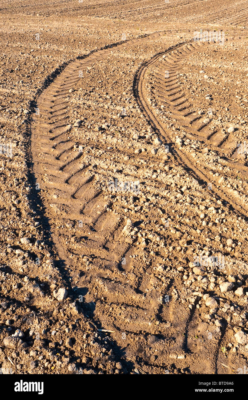 Il pneumatico del trattore le tracce in campo di fattoria - Francia. Foto Stock