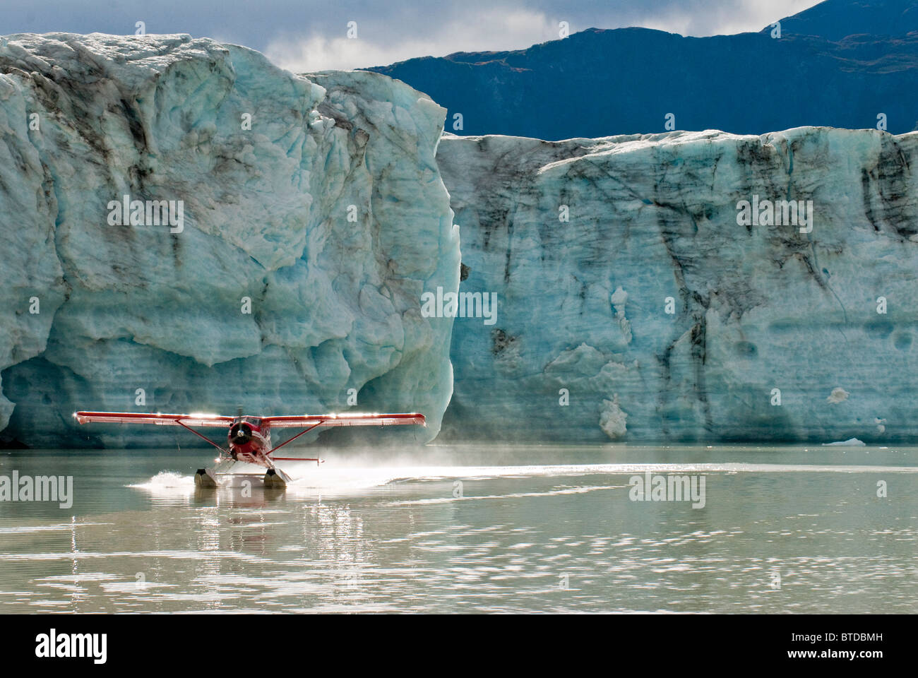 Un DeHavilland Beaver decolla da Strandline lago a bordo del Triumvirato ghiacciaio in Tordrillo Mountains, Alaska Foto Stock