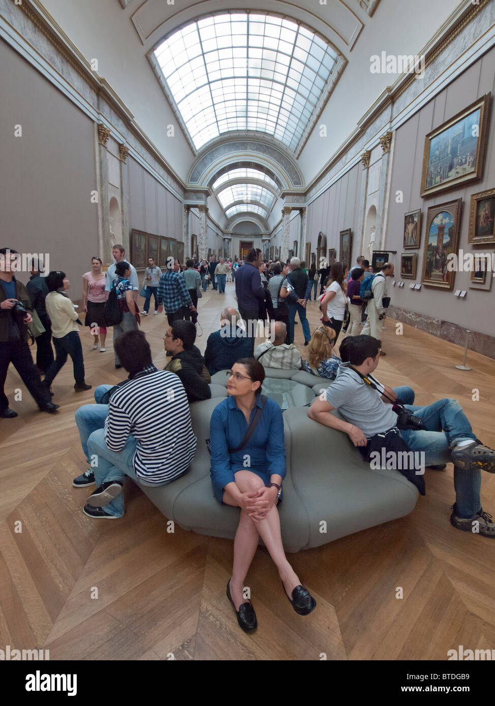 Interno del corridoio pieno di turisti nel museo del Louvre a Parigi Francia Foto Stock