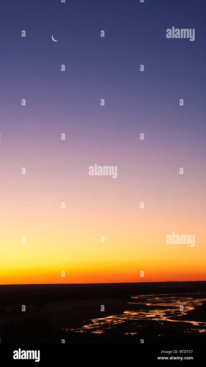 Paesaggio panoramico del Fiume Shashe al crepuscolo con una falce di luna Foto Stock