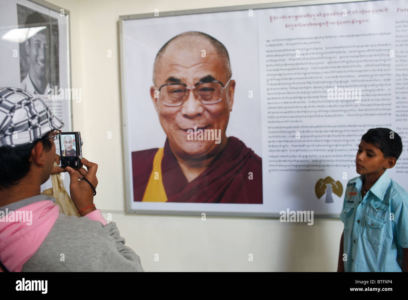 Una persona che prende una foto di un ritratto del Dalai Lama in un museo in McLeod Ganj, Dharamshala, India Foto Stock