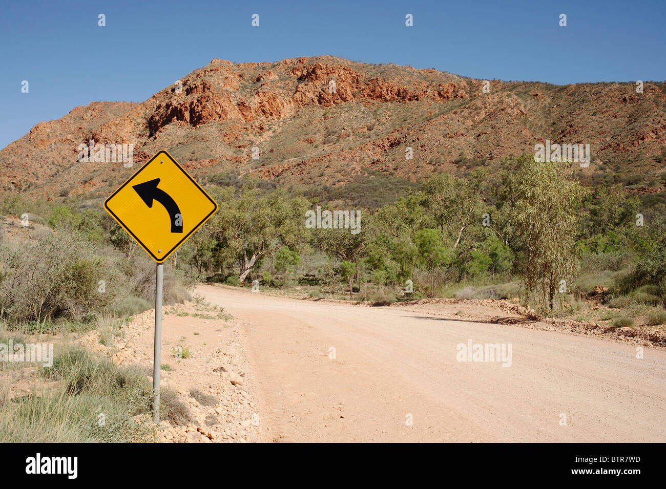 Australia, N'Dhala Gorge Road con segno di curva Foto Stock