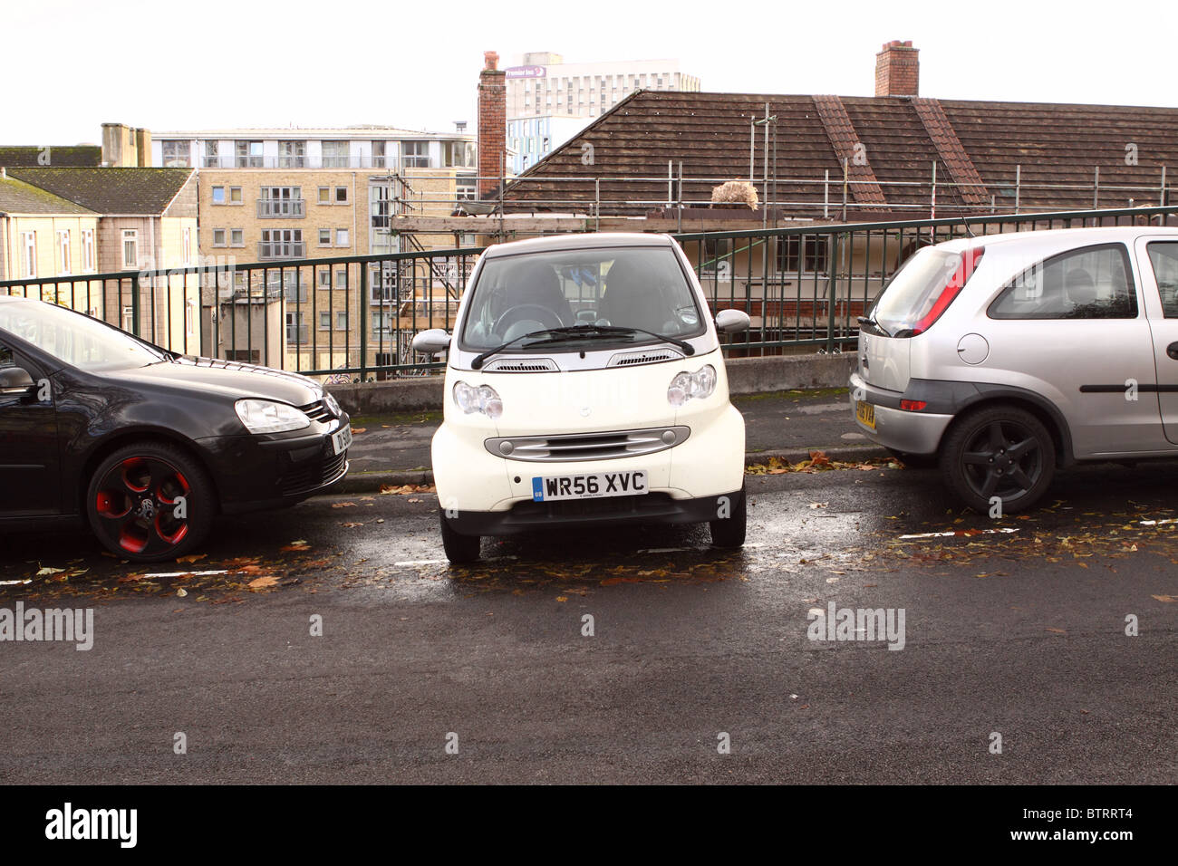 Smart Auto parcheggiate lateralmente perpendicolare su nella baia di parcheggio sulla collina di Stokes Croft Bristol Foto Stock