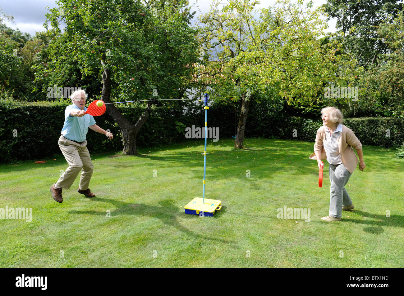 Coppia di anziani la riproduzione swingball Foto Stock