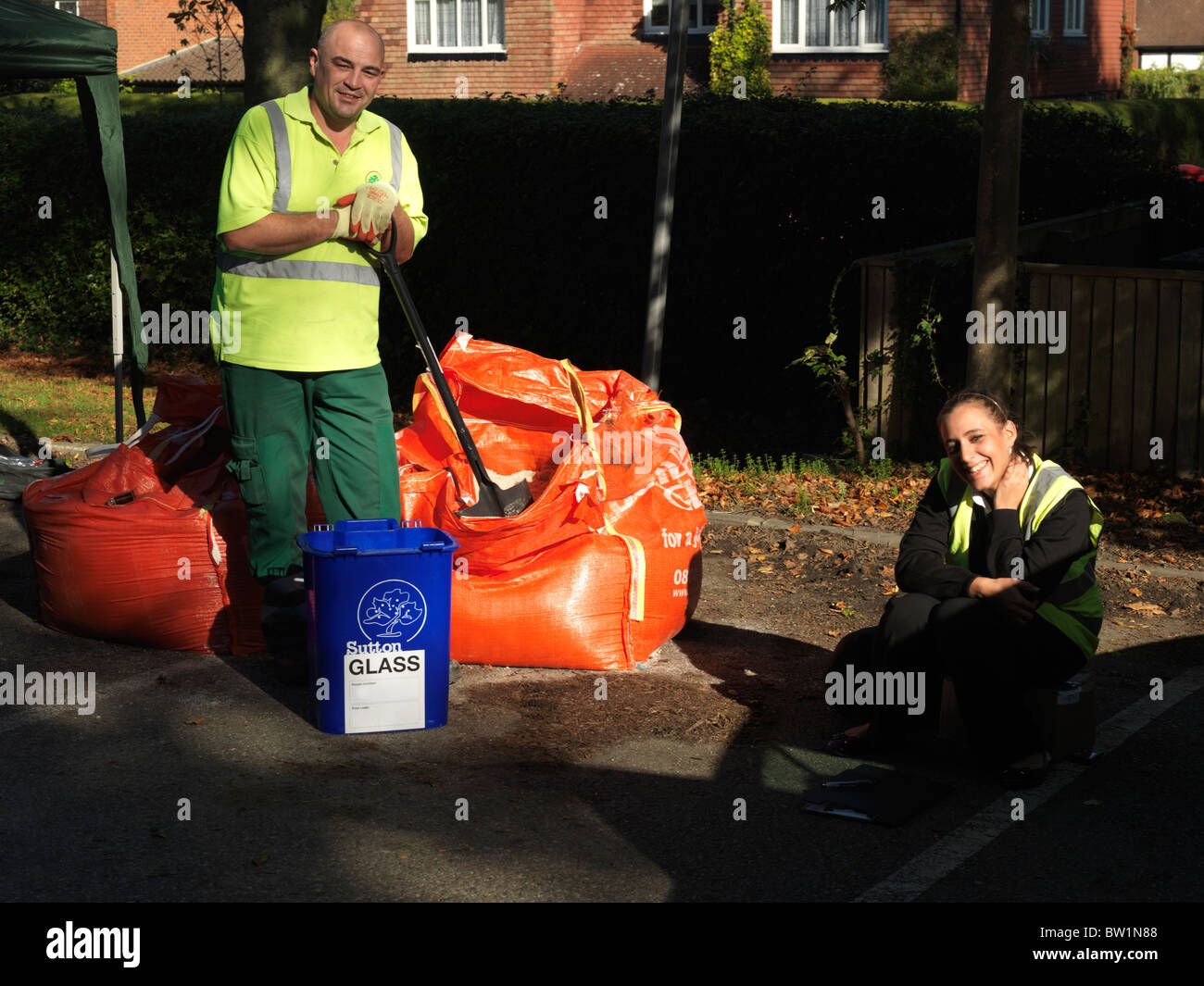 Vetro blu recycling bin riempito con libero Grana del Consiglio dare via la preparazione per la previsione di cattive condizioni atmosferiche, London Borough of Sutton Foto Stock