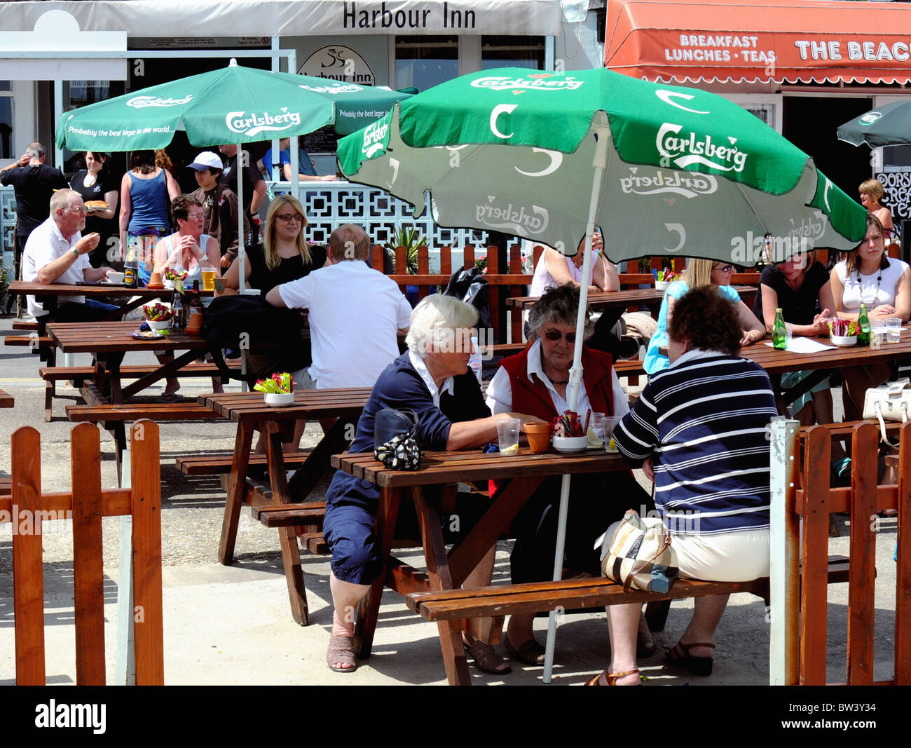 Persone in chat su una luminosa giornata d'estate Foto Stock