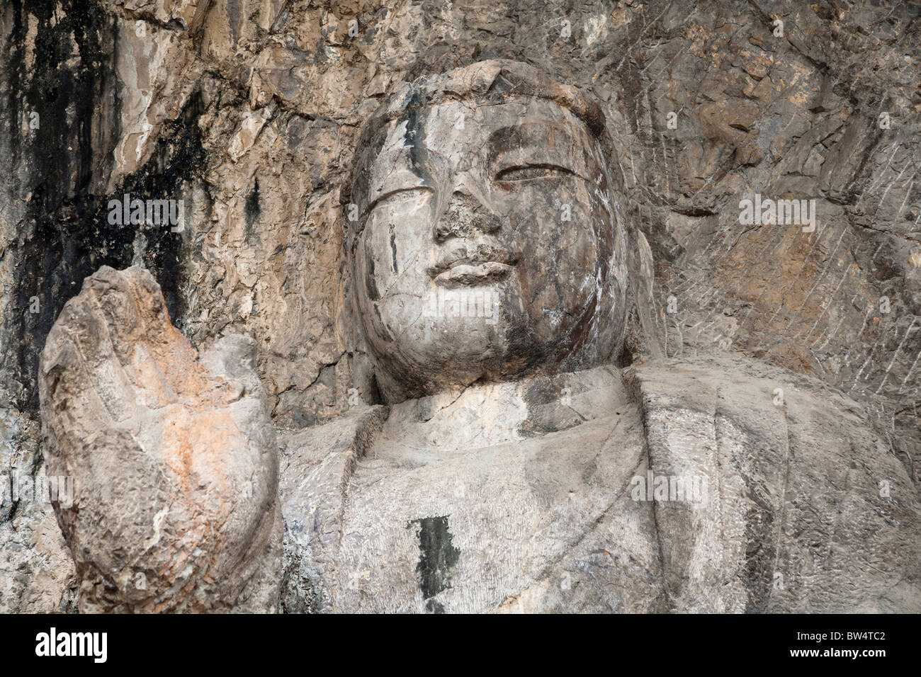 Una pietra scolpita Buddha, scavate nella roccia, le Grotte di Longmen e grotte, Luoyang, nella provincia di Henan, Cina Foto Stock
