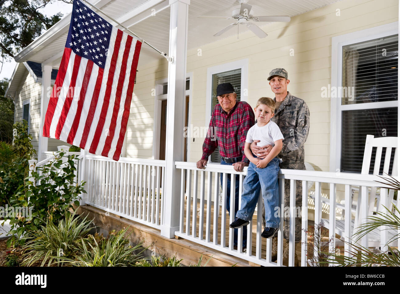 Uomo militare con la famiglia a casa dalla bandiera americana Foto Stock
