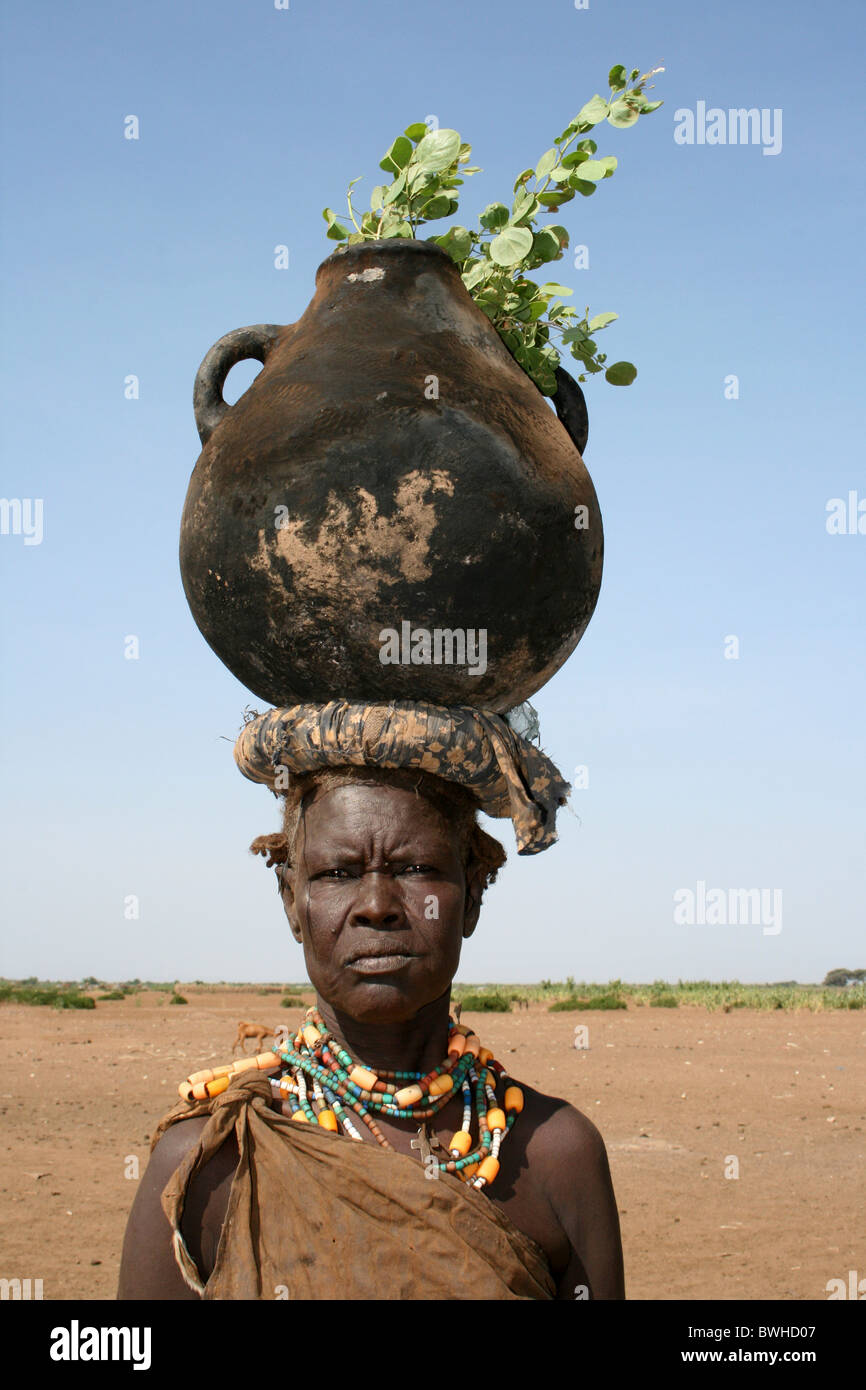 Dassanech Tribeswomen con pentola a pressione bilanciata sul suo capo, Omorate, Valle dell'Omo, Etiopia Foto Stock