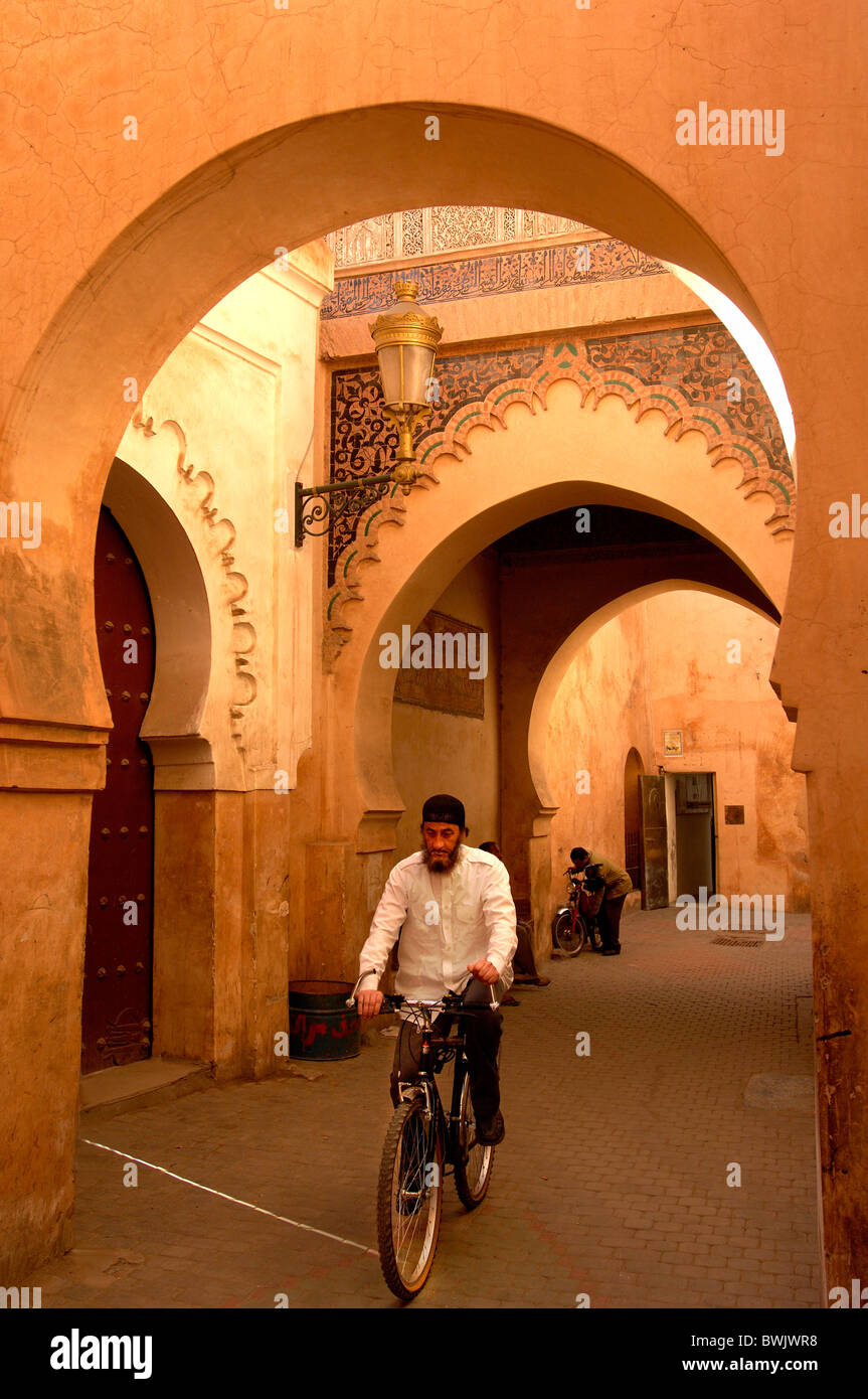 Medersa Ben Youssef uomo noleggio di bici scuola coranica Corano Islam Medina Marrakech Marrakech Marocco un Foto Stock