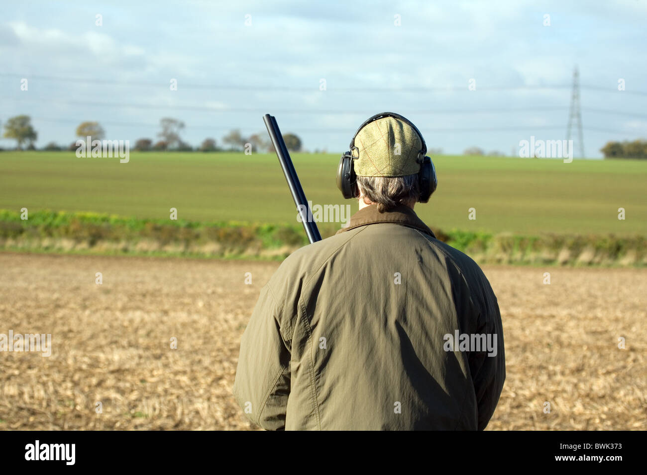 Un sparatutto (pistola) di attesa per la selvaggina di penna a salire su una ripresa in Cambridgeshire Regno Unito Foto Stock