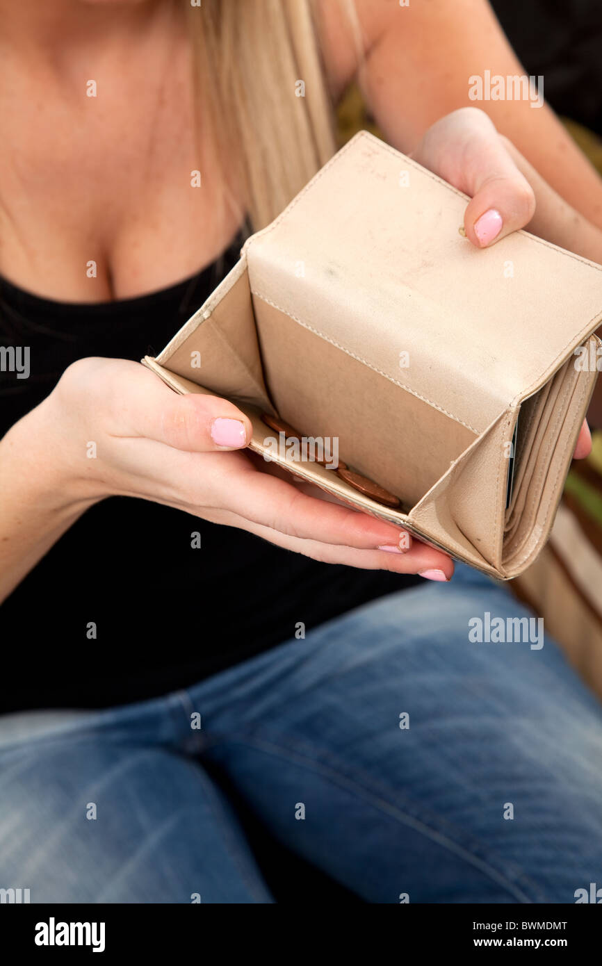 Giovane donna con il solo cambiamento allentato nella sua borsa. Foto Stock