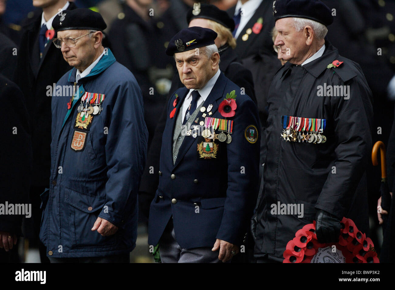I veterani con le medaglie e di papavero marzo passato presso il cenotafio in Whitehall sul ricordo domenica per commemorare le vittime della guerra Foto Stock