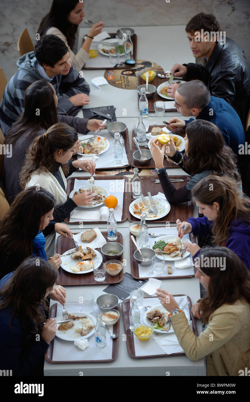 I giovani a mangiare in una mensa college Foto Stock