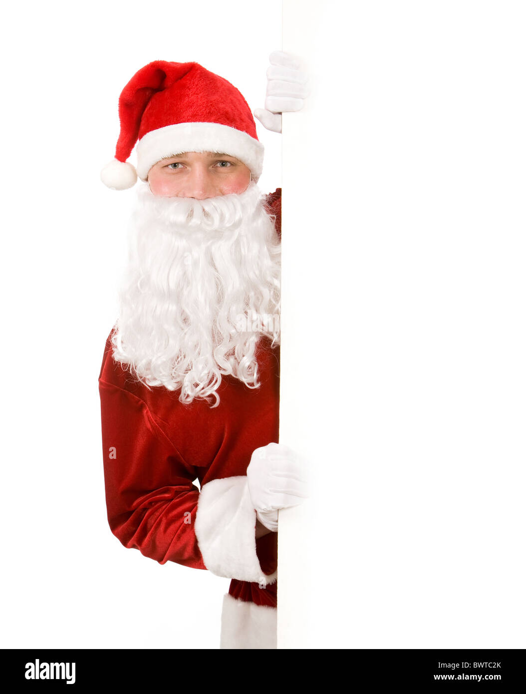Foto di felice Santa Claus guardando fuori di blank board Foto Stock