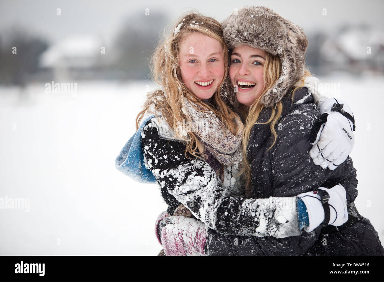Le ragazze adolescenti su Wimbledon Common godetevi l'inizio Dicembre neve invernale. Foto:Jeff Gilbert Foto Stock