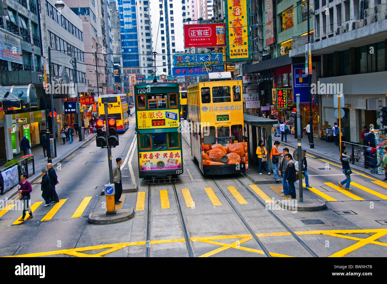 Tre double decker bus nella riga viaggia su una strada di città nel centro di Hong Kong Cina Foto Stock