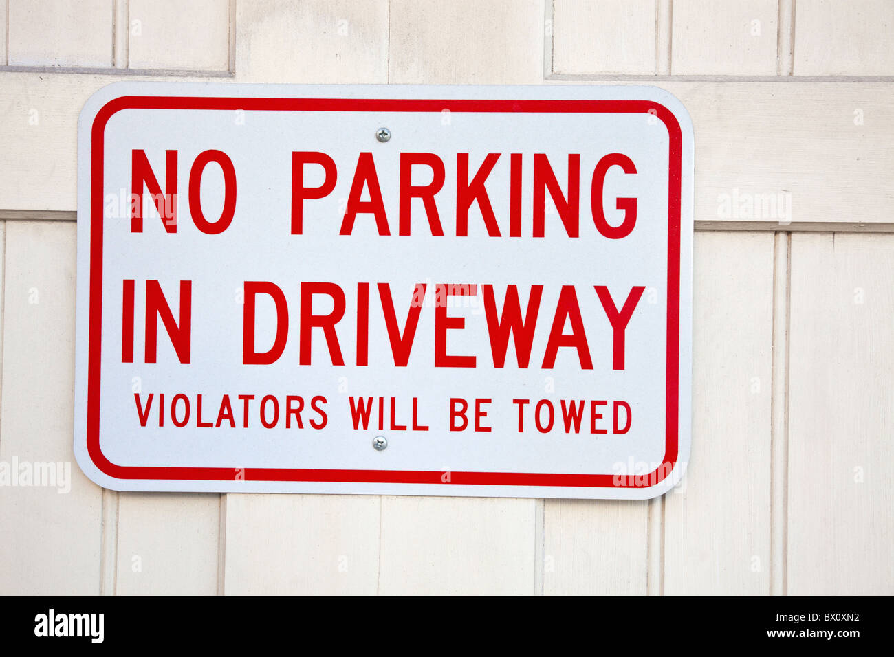 Non parcheggiare sul viale di ingresso - segno sulla porta del garage Foto Stock