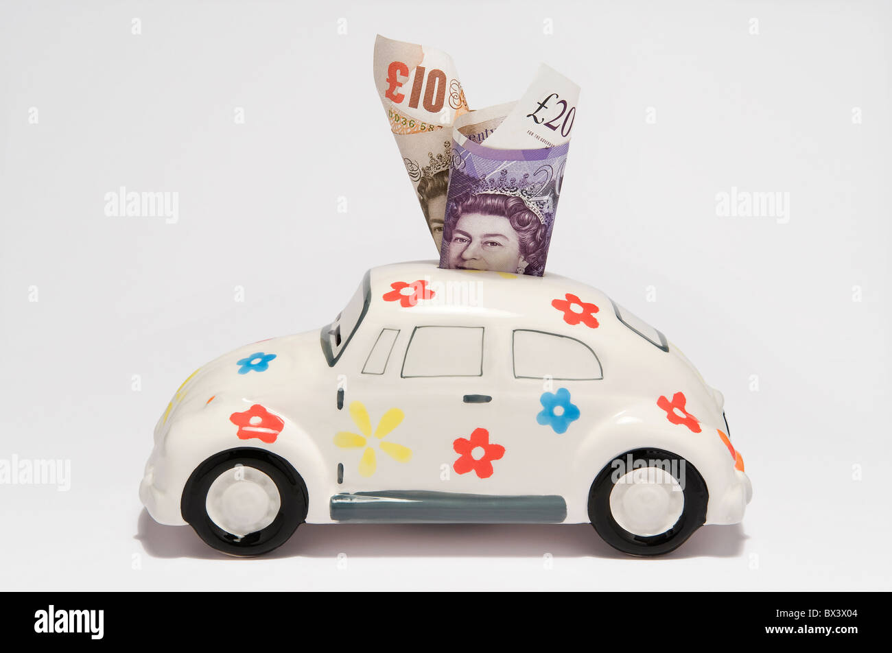 Aumento dei costi dell'automobilismo, contanti in denaro box auto Foto Stock