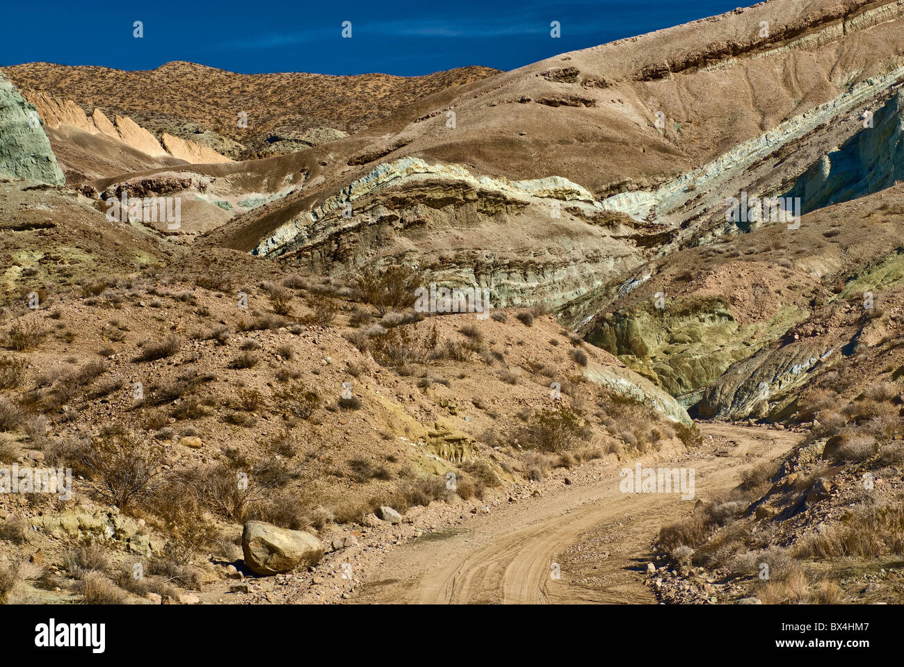 Strada sterrata, formazioni rocciose a Rainbow bacino naturale nazionale Landmark, fango sulle colline vicino a Barstow, Deserto Mojave, CALIFORNIA, STATI UNITI D'AMERICA Foto Stock