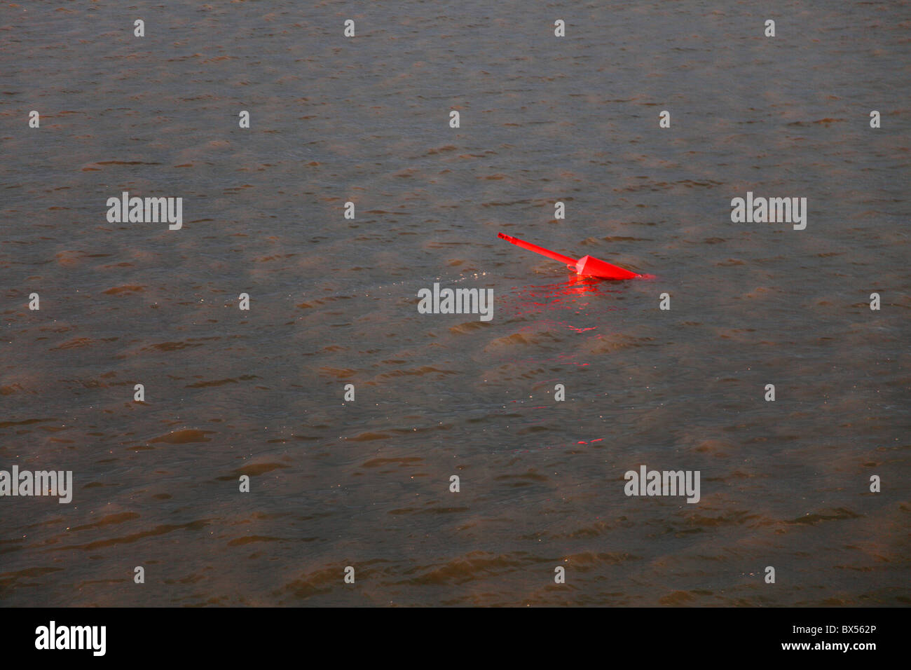 Boa rosso è bob in su e in giù in grigio le inondazioni del mare del Nord. Foto Stock