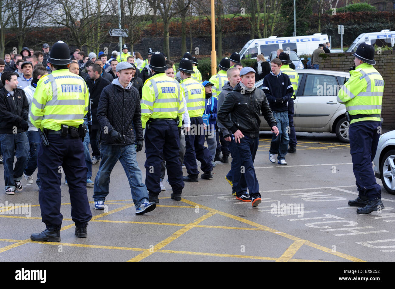 Gli ufficiali di polizia controllare i tifosi di calcio in arrivo per una partita a Molineux Foto Stock