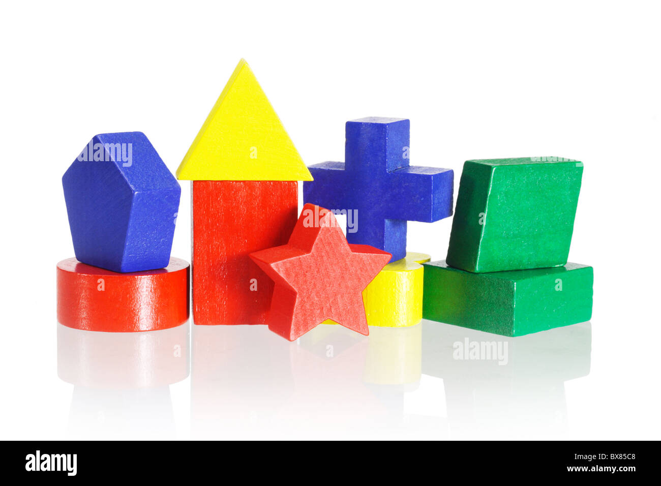 Colorati blocchi geometrici disposti su sfondo bianco con la riflessione Foto Stock