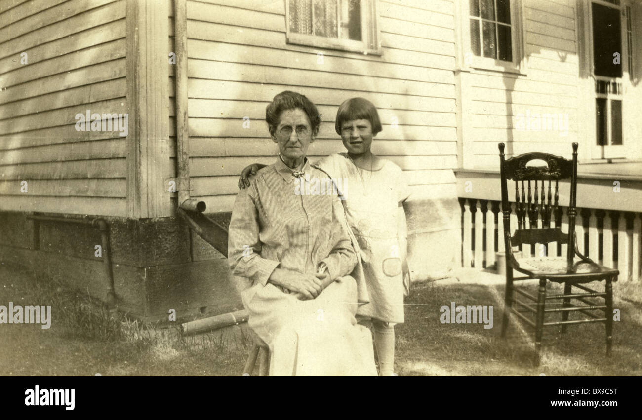 Nonna e nipote 1920s 1930s America rurale Sedia legno casa generazioni architettura americana in bianco e nero Foto Stock