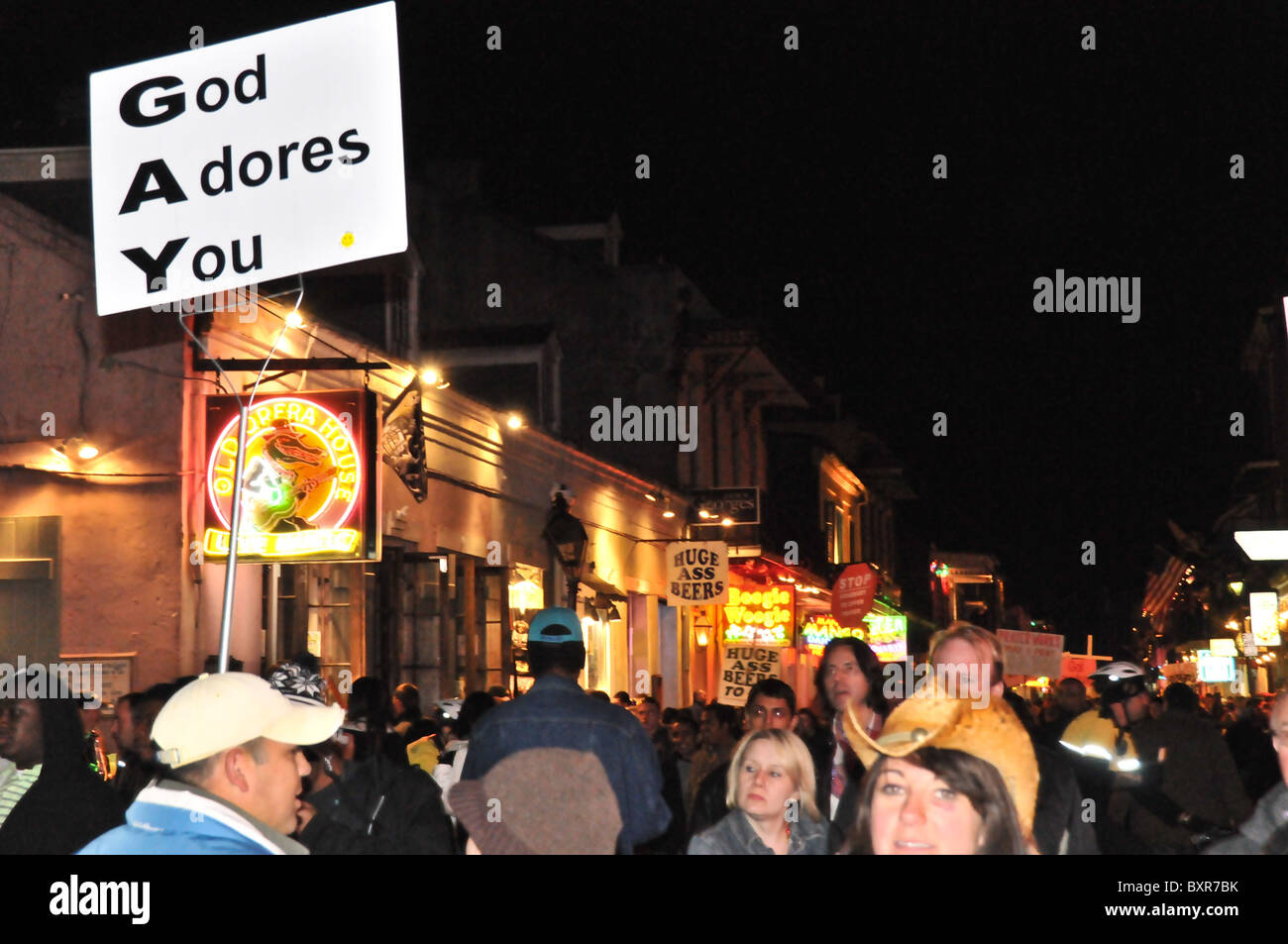 Attivista religiosa con "Dio ti adora' firmare su Bourbon Street, Quartiere Francese, New Orleans, Louisiana Foto Stock